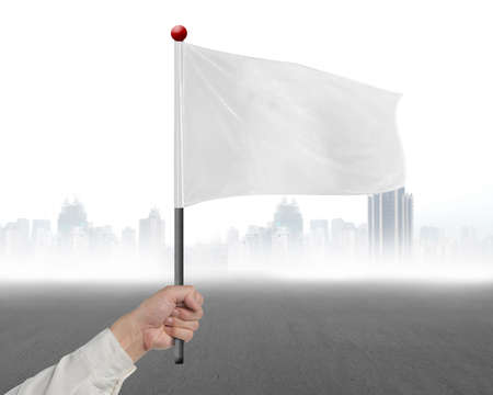 man hand holding blank white flag with gary cityscrape backgroundの写真素材