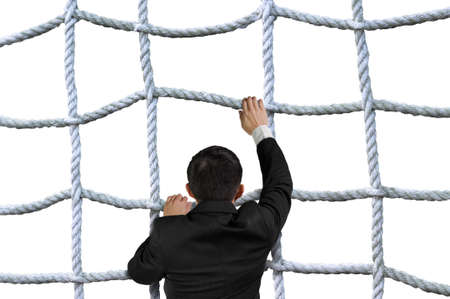 Businessman climbing the crisscross rope net isolated on white backgroundの写真素材