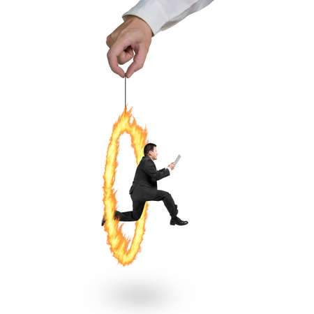 Businessman jumping through fire circle hand holding isolated on white backgroundの写真素材