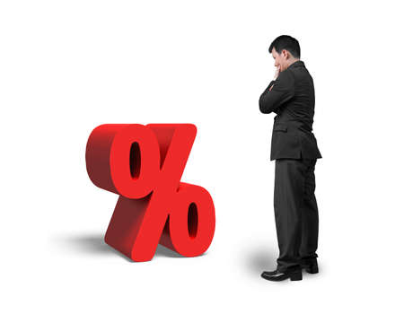 Thinking salesman looking at red percentage sign isolated on white backgroundの写真素材