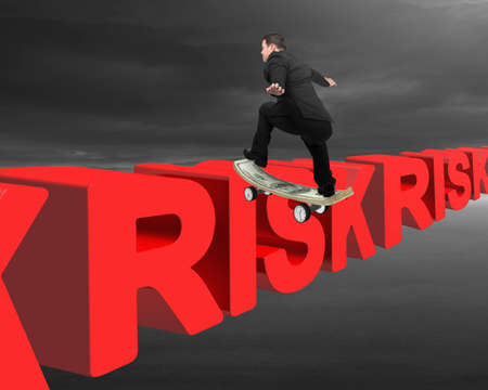 Businessman skating on money skateboard across red risk 3D text with cloudy sky background