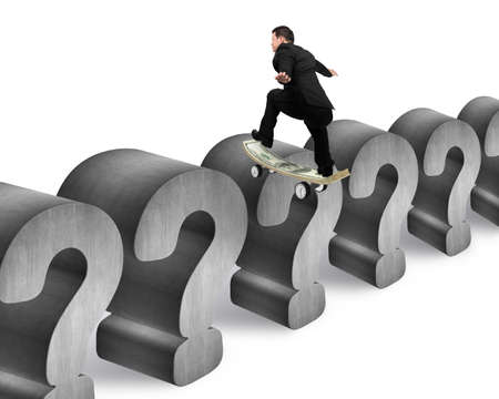 Business man skating on money skateboard across concrete question mark with white backgroundの写真素材