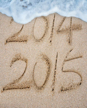 New year 2015 replace 2014 on sand beach background
