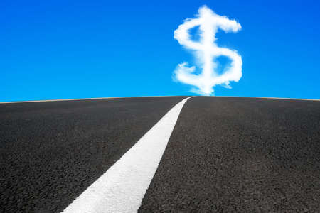 Dollar sign shape cloud in blue sky with asphalt road and separation white line backgroundの写真素材
