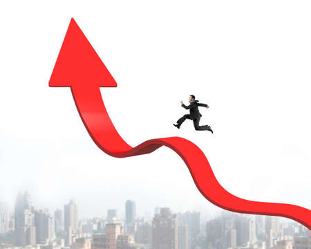 Businessman running on red arrow up bending trend line with cityscape skyline backgroundの写真素材
