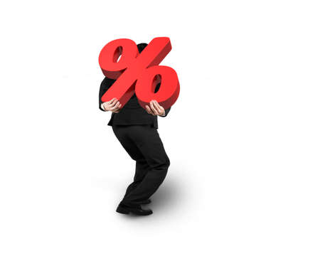 Business man carrying big 3D red percentage sign isolated on white backgroundの写真素材