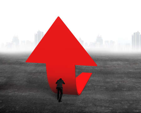 Businessman pushing red trend 3D arrow upward on concrete floor with cityscape skyline backgroundの写真素材