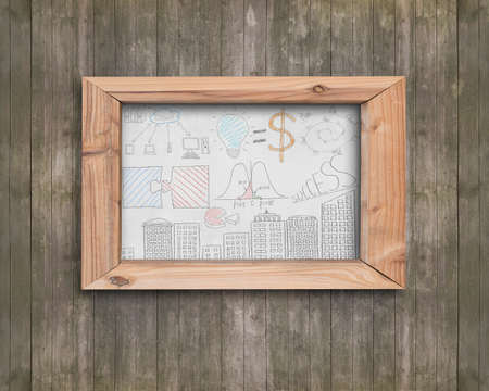 Whiteboard of wooden frame with business concepts doodles on old brown wood wall