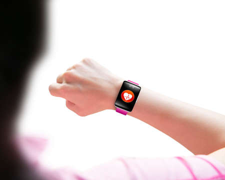 Sport woman looking at health sensor smart watch hand wearing, isolated on white backgroundの写真素材