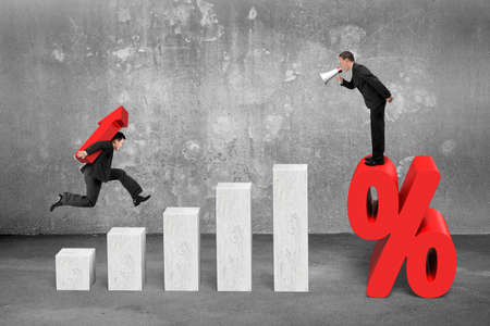 One businessman using speaker shouting on percentage mark, another carrying arrow up sign jumping on...