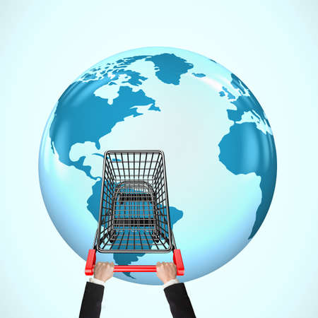 Hands pushing empty shopping cart on 3D globe with world map, global shopping concept.の写真素材