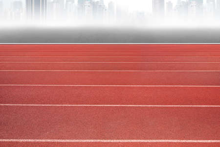 Running track, with gray city skyline background.