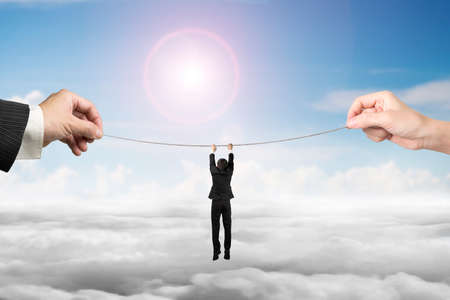Businessman hanging on tightrope with man and woman hands holding two sides, on sun sky cloudscape...