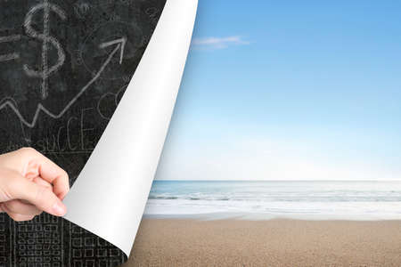 Woman hand open natural sea beach page to replace business concepts doodlesの写真素材