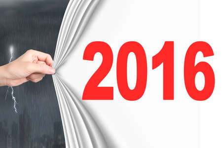 Woman hand pulling new 2016 white curtain covering lightning stormy weatherの写真素材