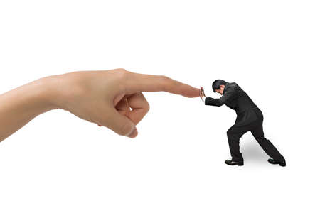 Small businessman pushing against big hand forefinger, isolated on white.の写真素材