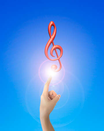 Human hand forefinger pointing at 3D music note with bright light, on blue background.の写真素材