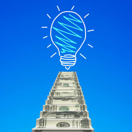 Money stairs toward light bulb hand drawing, in blue sky background.の写真素材
