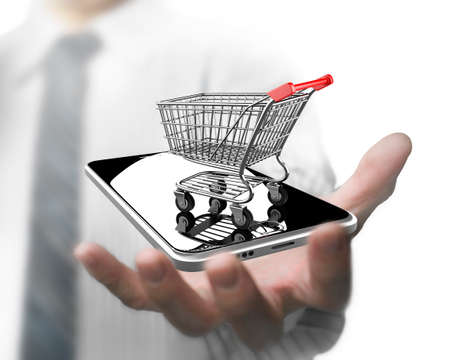 Businessman hand holding shopping cart with smart phone, on line shopping concept.の写真素材