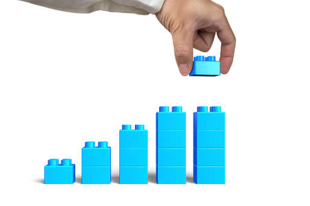 Human hand holding a blue block to complete growth bar graph shape, isolated on white background.