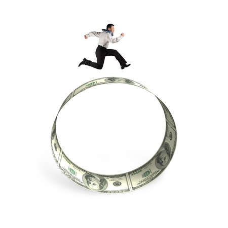 Man running on the circle of dollar bills, isolated on white background.の写真素材