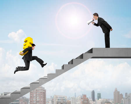 Leader, boss holding speaker shouting at employee carrying Euro running on concrete stairsの写真素材
