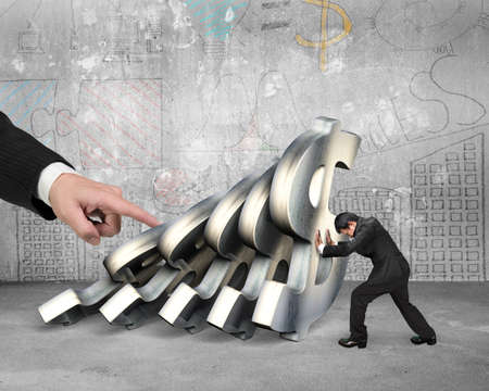 Businessman stopping the falling of dollar currency symbols with big hand pushing, on business doodles wall concrete indoors background. Domino effect and problem solving of conceptsの写真素材
