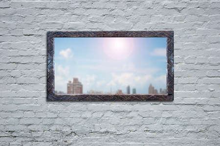 Wooden board with sunny sky cityscape view on old bricks wall.の写真素材