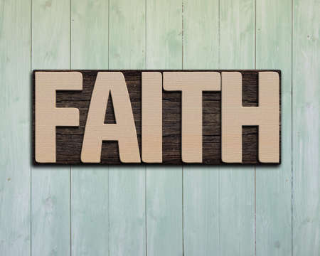 Faith wooden word on green wood wall.の写真素材