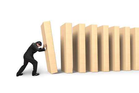 Man pushing and putting dominoes in line, isolated on white background.の写真素材