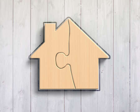 Wooden house shape puzzles, on wood wall background.の写真素材