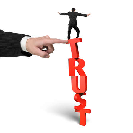 One man stopping red vertical trust word, with another big man's hand helping, isolated on white.の写真素材