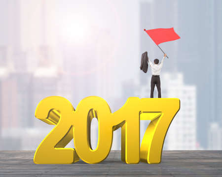 Man waving red flag standing on 2017 year, golden numbers, on city buildings background.の写真素材
