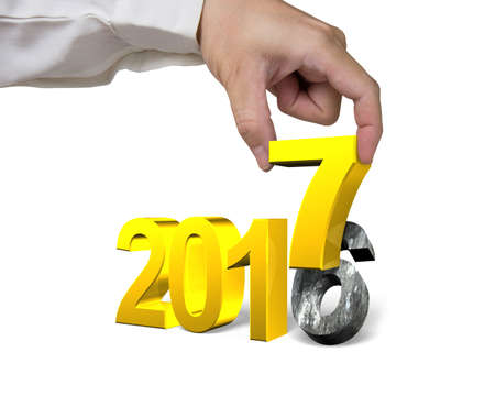 Hand holding 2017 year, golden number, isolated on white background.