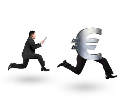 Man using digital tablet and running after Euro money symbol with human legs running, isolated on white background.の写真素材