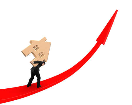 Businessman carrying wooden house on red arrow up graph, isolated on white background.の写真素材