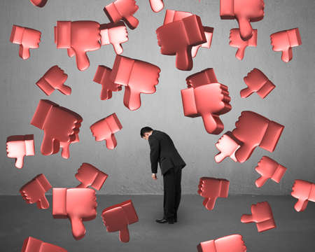 Falling red 3D thumbs down with man tired.の写真素材