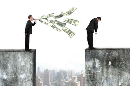 Boss using megaphone yelling at the tired employee with spraying out dollar bills, on top of high concrete wall, isolated on white.の写真素材
