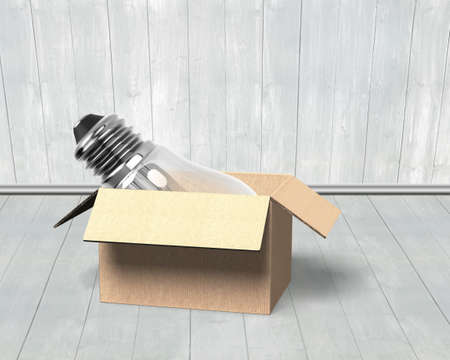 Light bulb in opened cardboard box, on wooden wall and floor indoors background.