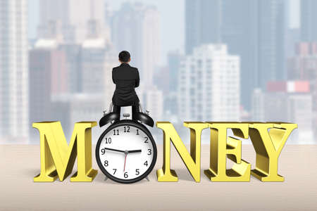 Man sitting on alarm clock with gold money word, on city buildings background.