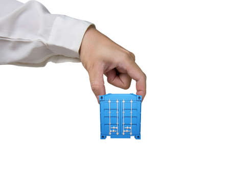 Man fingers holding 3d blue cargo container, isolated on white background.の写真素材