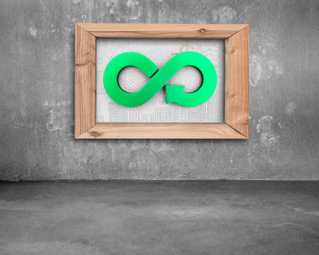 Circular economy concept. Green arrow infinity recycling symbol on the doodles board with wooden...