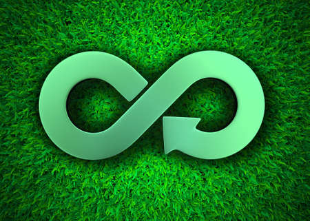ECO and circular economy concept. Metallic arrow infinity recycling symbol on green grass meadow...