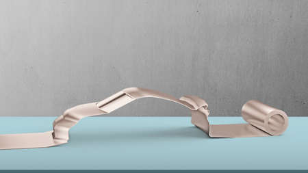 Metal roller sheet in sport car shape on table with concrete wall background, concept of energy...