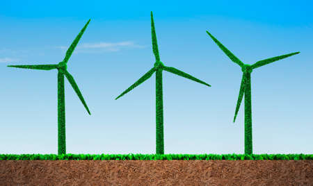 Green grass in wind turbines shape, on blue sky and soil cross section background, concept of ECO, renewable energy and circular economy.の写真素材