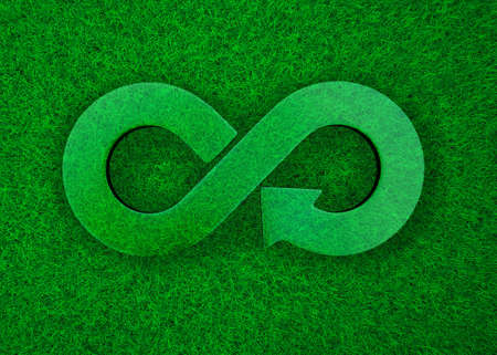 ECO and circular economy concept. Transparent arrow infinity recycling symbol on green grass meadow...
