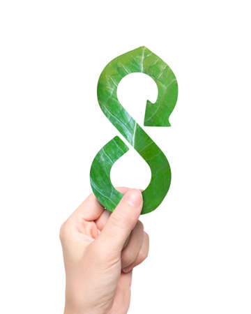 Green Eco-friendly and circular economy concept, female hand holding a leaf in form of arrow infinity recycling shape, isolated on white background.の写真素材