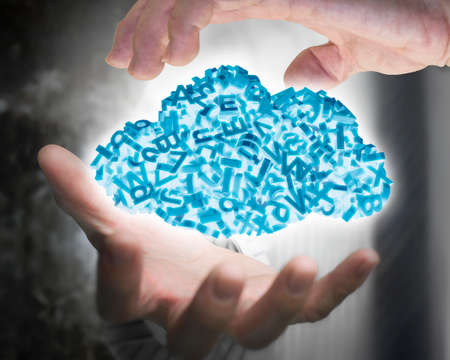 Big data and cloud computing concept. Businessman hands holding blue cloud of 3d letters and numbers, self-illuminated.の写真素材
