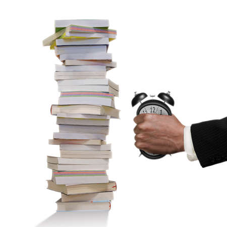 Concept of many books need to read, but not enough time. Man fist clenched the deformed alarm clock...