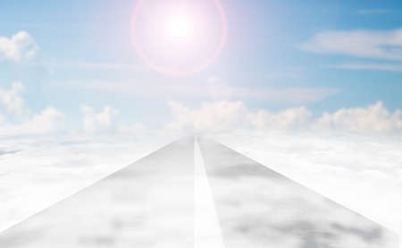 Asphalt road of white line in the sky with sunlight and white clouds background.の写真素材
